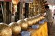 Thailand: A man plasters gold leaf on luk nimit (holy stone spheres), Wat Phrathat Doi Kham, Chiang Mai