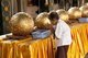 Thailand: A woman devotee and luk nimit (holy stone spheres), Wat Phrathat Doi Kham, Chiang Mai